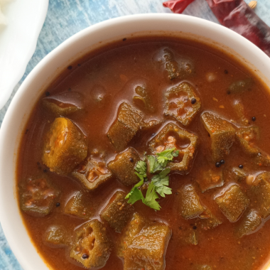 Benedekayi Gojju is a traditional recipe from Mysore region of Karnataka, referring to sautéed okra in a tangy, spicy sauce. Served with hot rice, curd rice or chapatis.