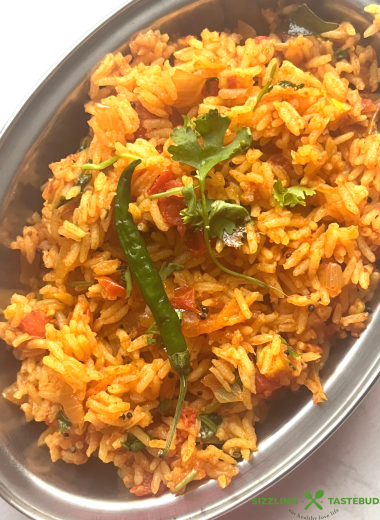 Tomato Rice is a gluten free, Vegan and Easy One Pot meal made with tomatoes, Cooked rice and everyday spices. Works for lunchbox or potluck too.