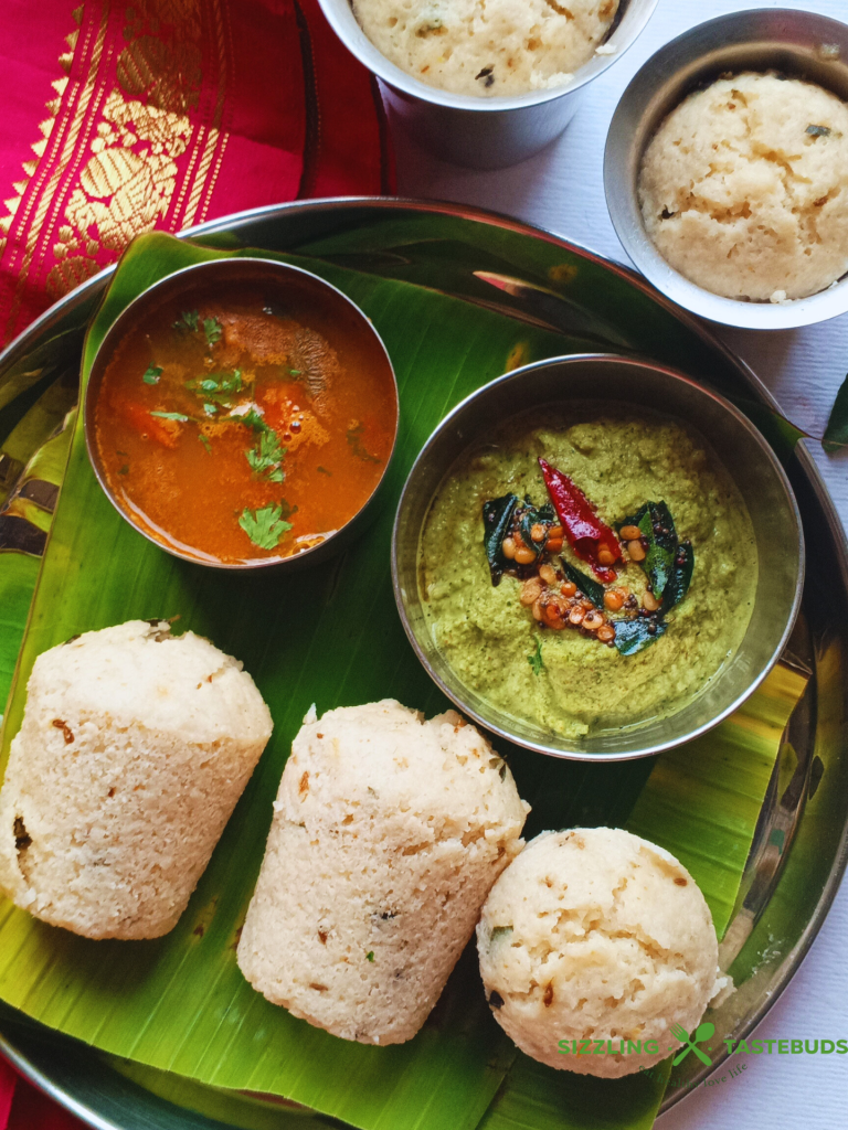 Kanchipuram Idli, a traditional dish from Tamil Nadu, is a spiced, steamed rice cake known for its unique blend of cumin, pepper, and ginger, offering a savory twist on the traditional Idli.
