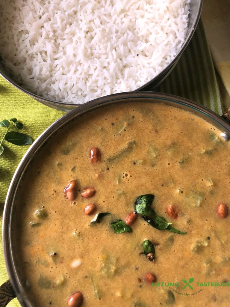 Pudalangai Paal Kootu is a rustic, Gluten Free Vegan + Curry made with snake gourd, Coconut milk and a spice paste. Served with steamed rice or Chapati.